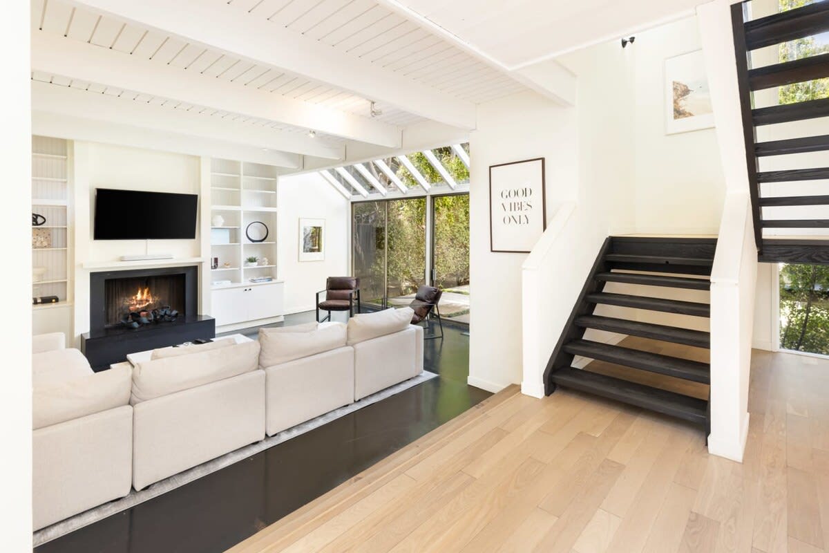 Sit back and relax on the designer couch in front of the fireplace and flat screen TV