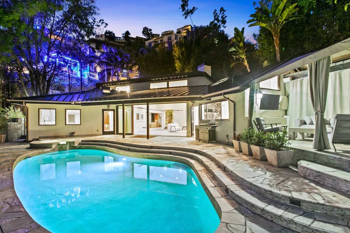 Outer pool area with side cabana and heated pool. Enjoy music and a warm pool