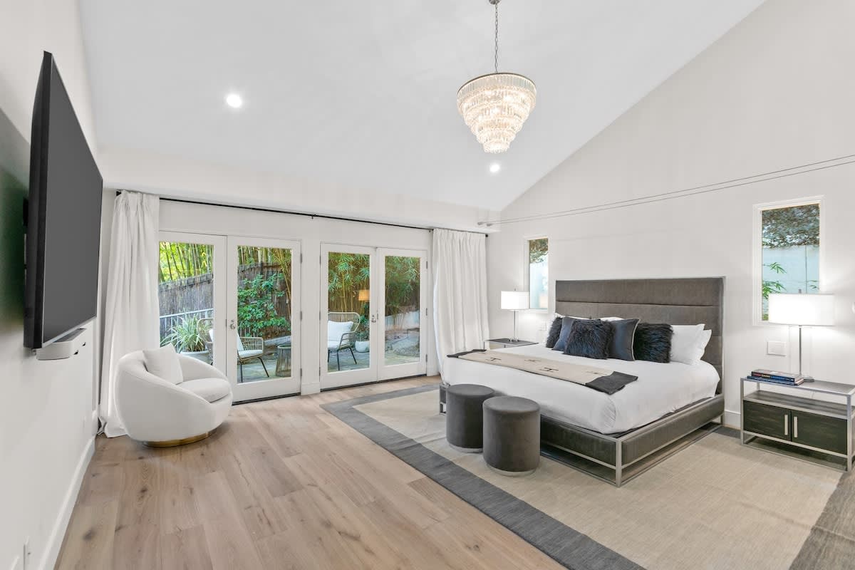 The master bedroom boasts a 70 inch TV, and a king bed