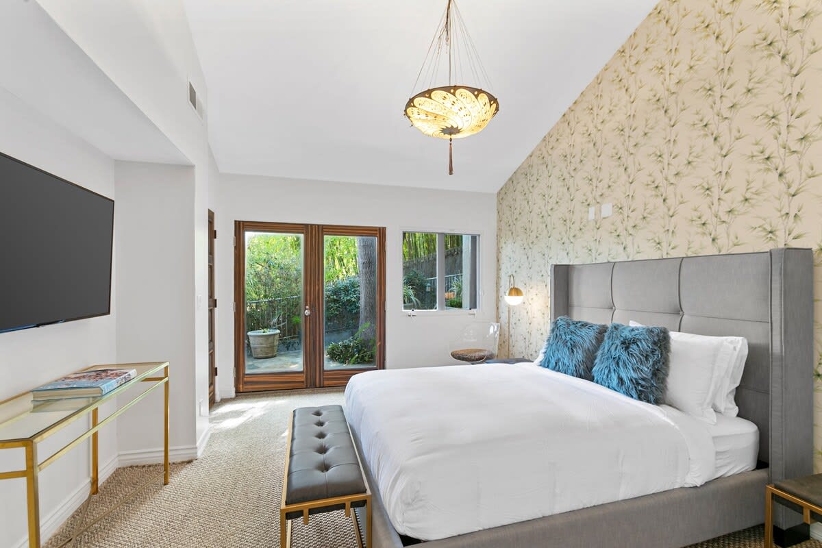 Guest bedroom with queen bed and smart TV