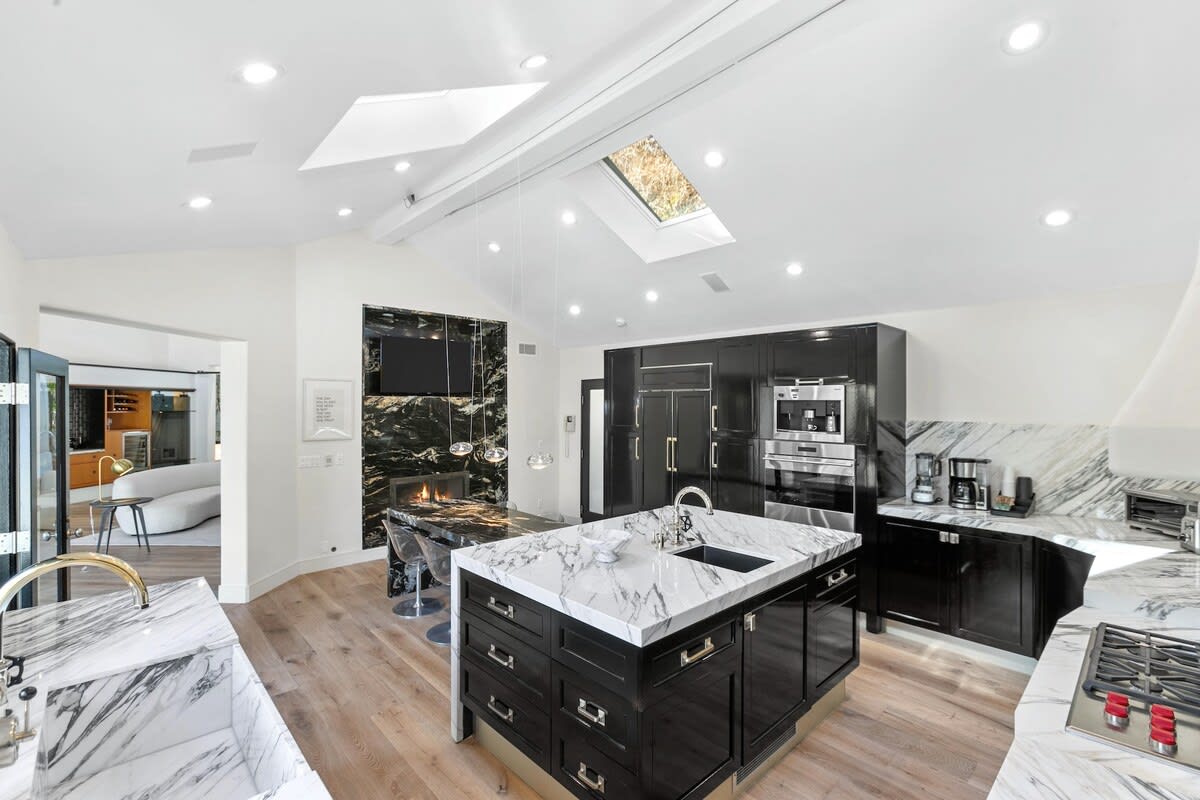 Full of all the essential appliances, freeze - fridge, coffee maker, microwave, 5 burner wolf over and stove top