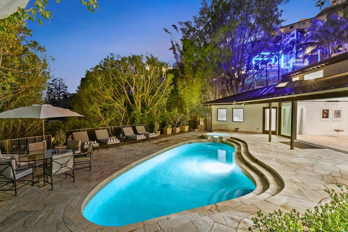 Pool area at night with Hollywood Skyline