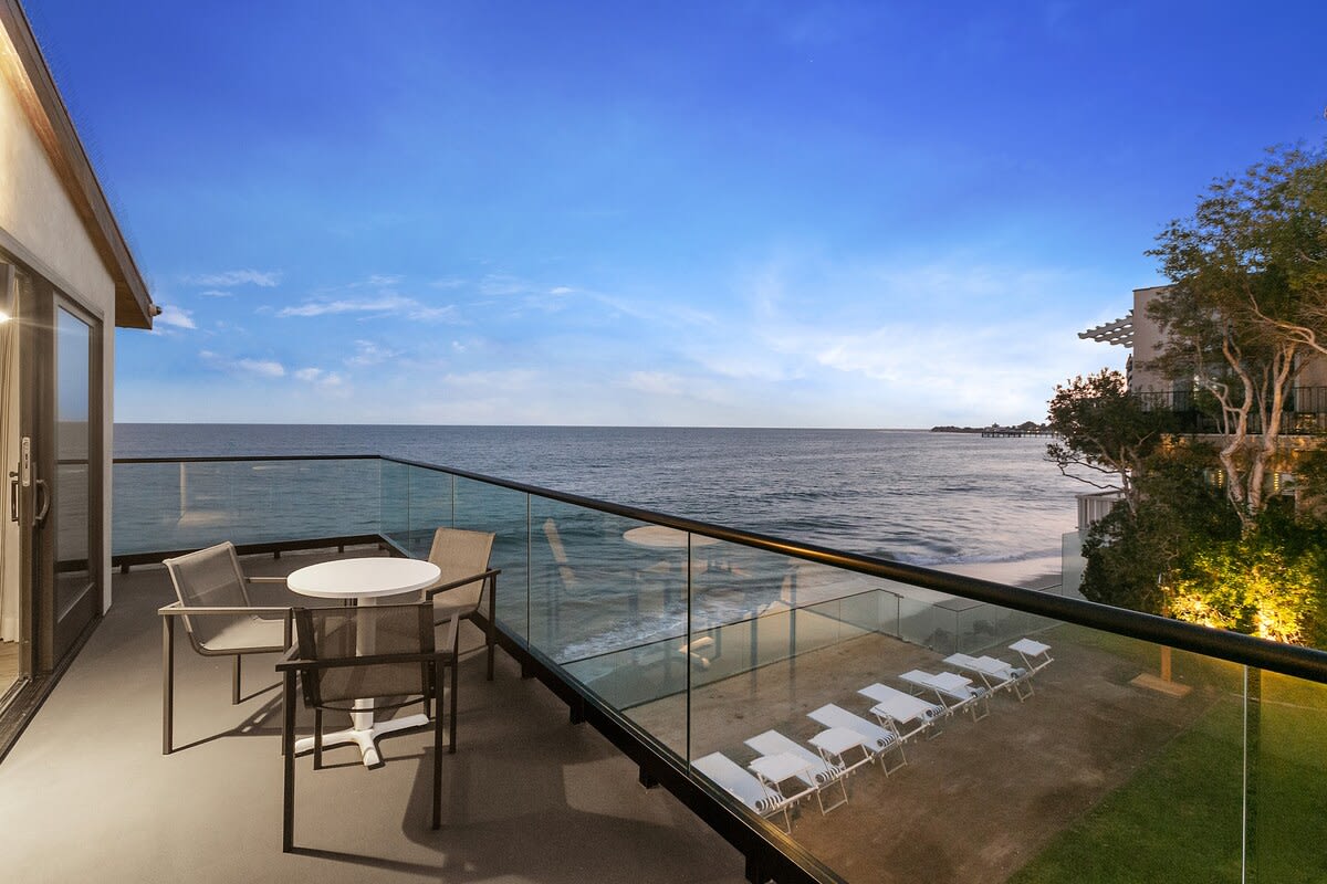 With your sparkling champagne in hand, watch the sunset dim the sky from your private balcony space