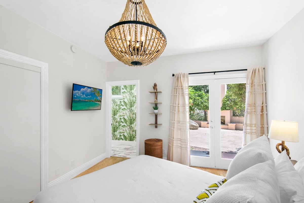Guest bedroom with en-suite bathroom and patio access.