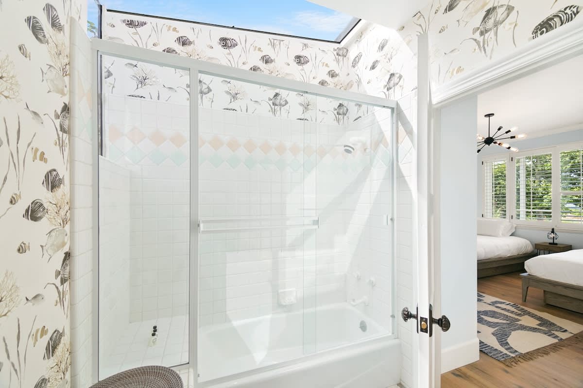 Guest bedroom full bathroom shower and natural skylight.