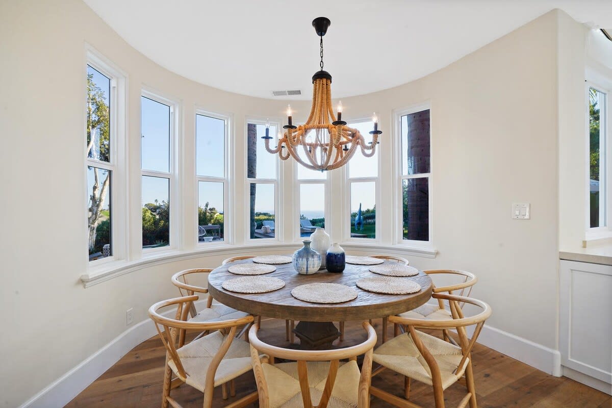 A charming dining area overlooking the luxurious backyard area.