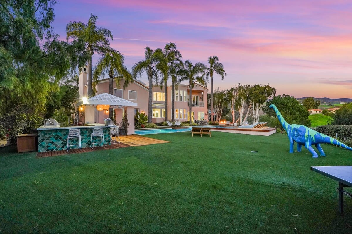 Enjoy a drink at the outdoor bar with a sunset backdrop.