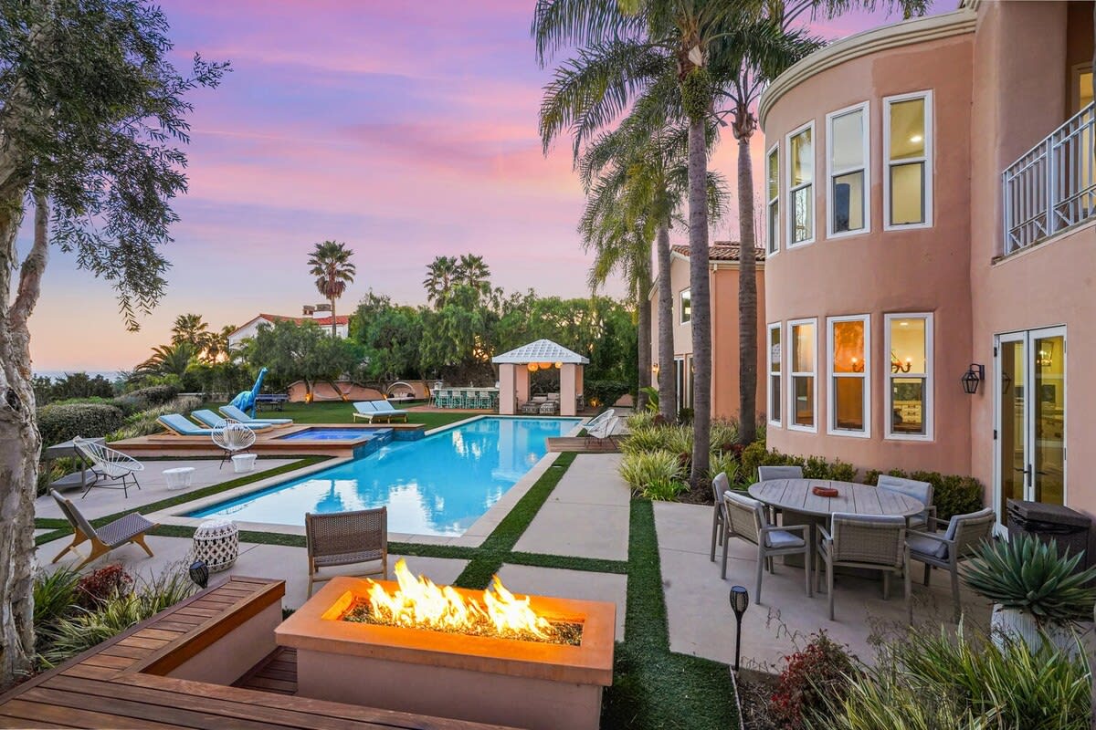 By night, set the mood with the outdoor fire pit and twinkling sky.