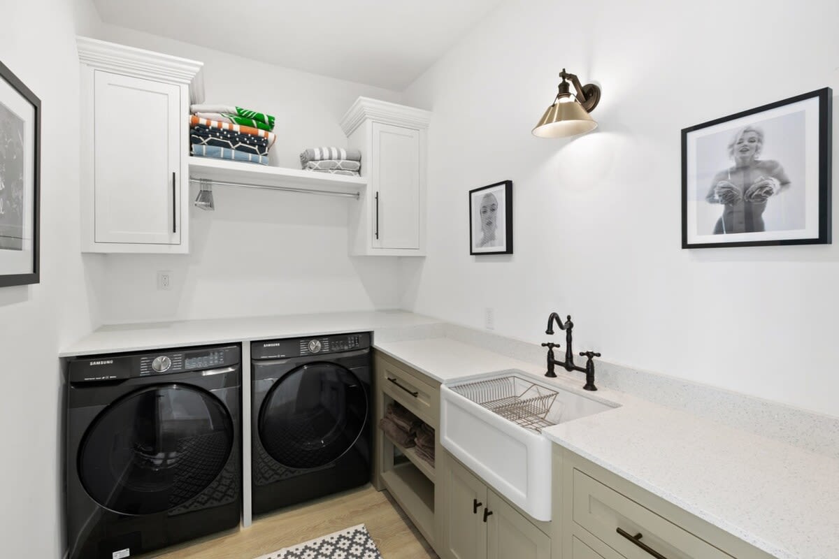 Laundry space with state of the art washer and dryer and spacious folding/storage area.