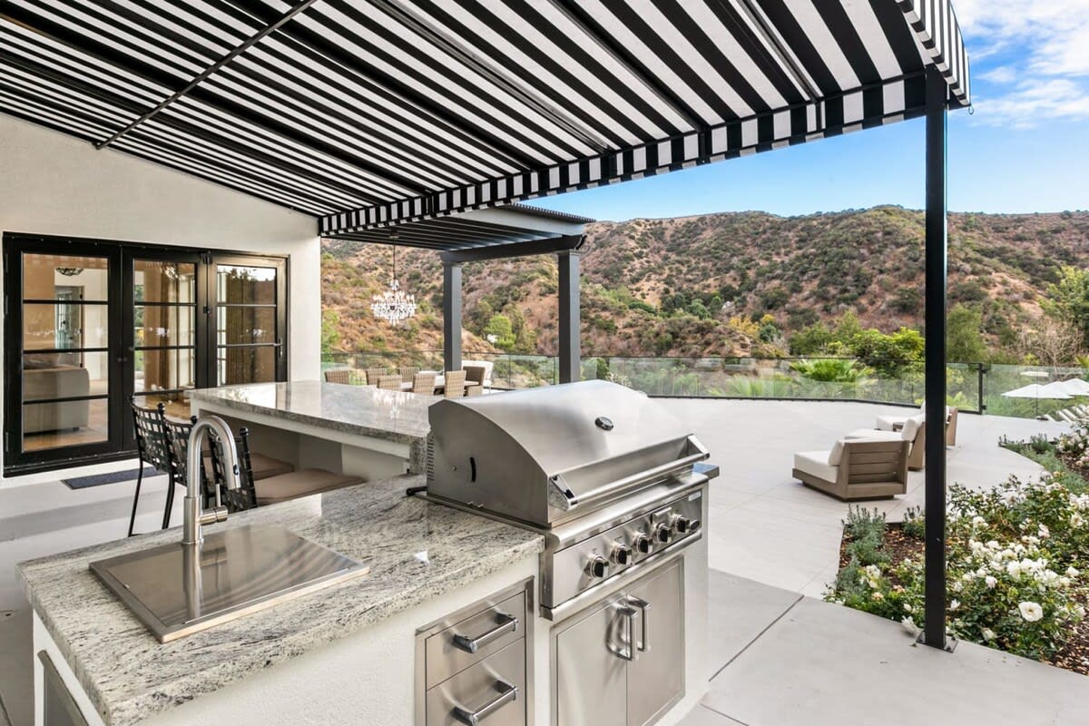 Covered BBQ and patio area has expansive views of the Beverly Hills.