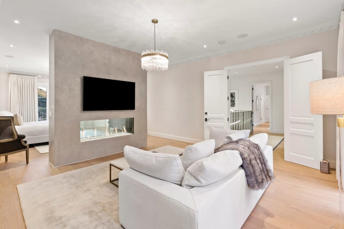 Curl up in the master bedroom with a good book or movie next to this dual sided fireplace.