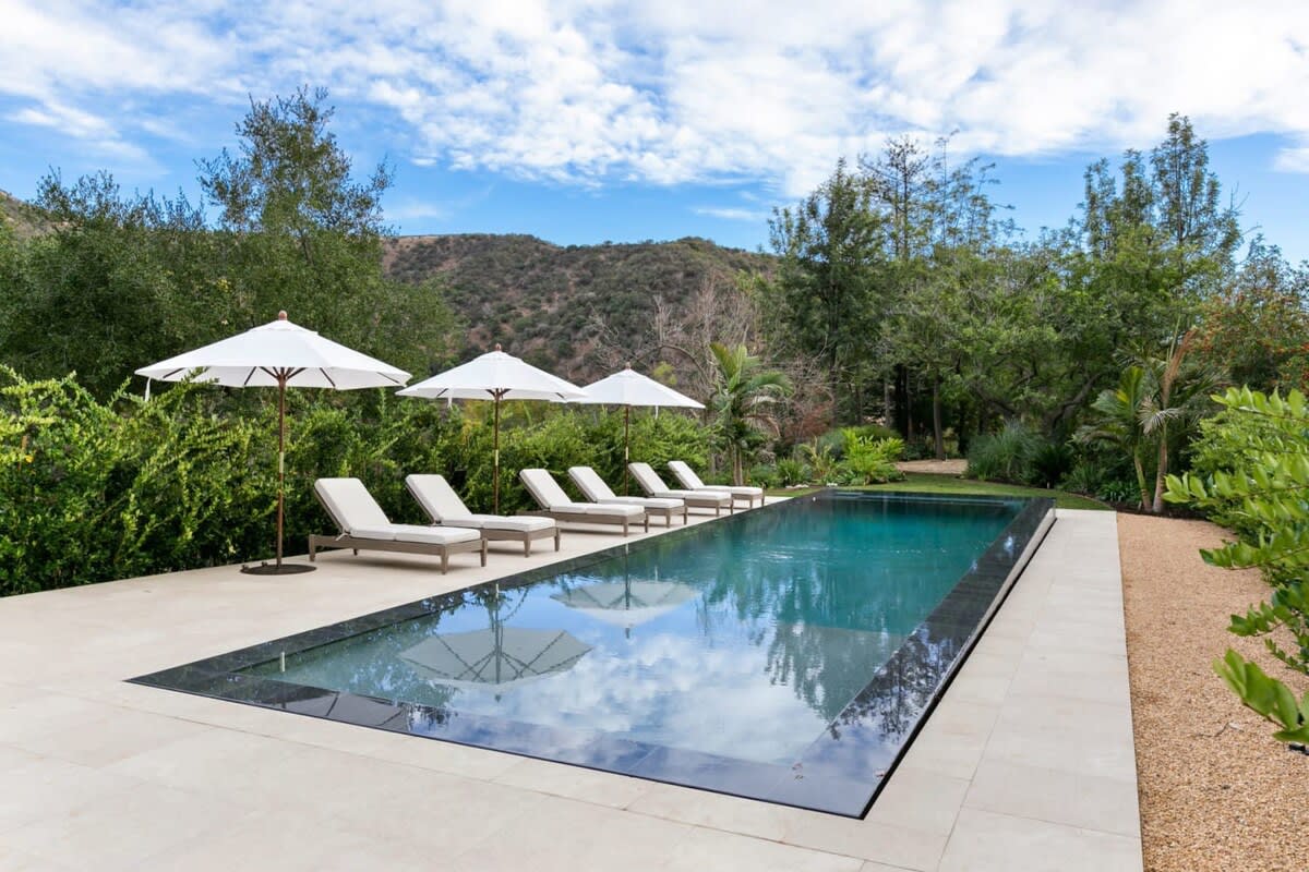 Zero edge pool makes this backyard space great for entertainment and exercise alike.