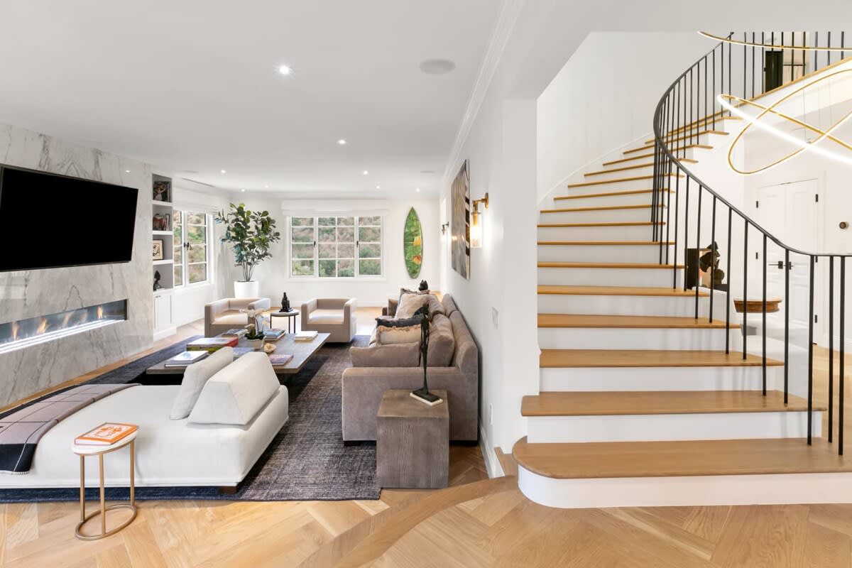 Grand staircase sits next to this large state of the art entertainment space.
