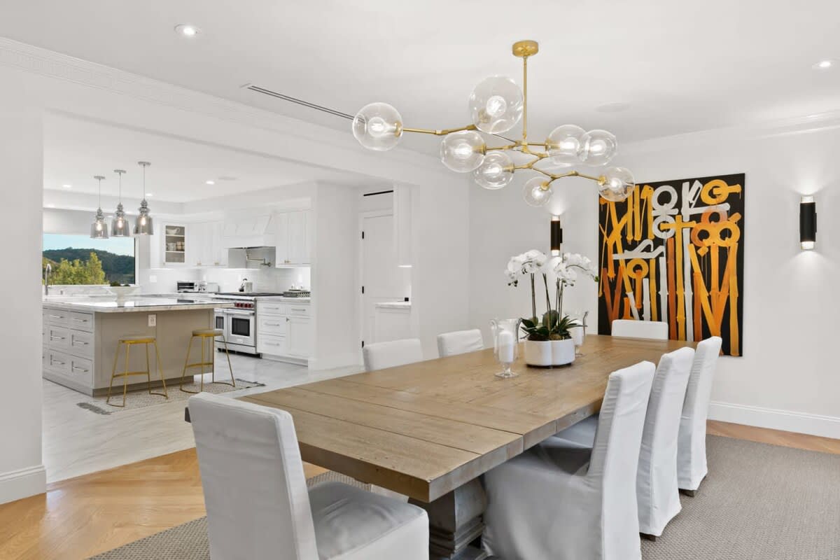 Large wooden dining table with raised chairs is perfect for indoor dining occasions.