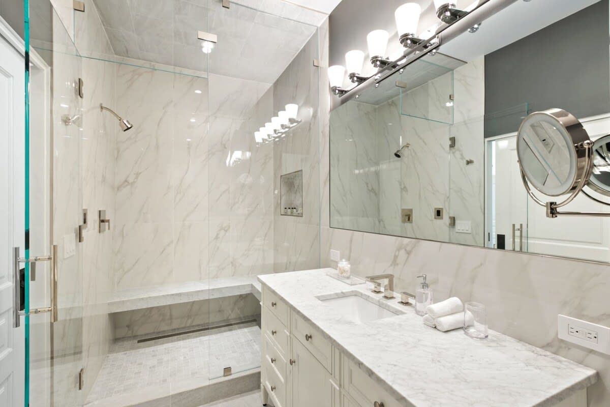 Marbling and glass make this bathroom an ultra luxury oasis.