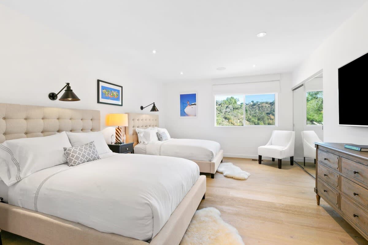 Large guest bedroom equipped with 2 Queen beds with views of Beverly Hills.