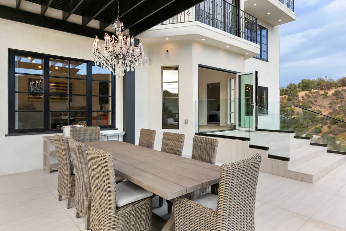 Exquisite outdoor dining table with combination of old and new world design touches.