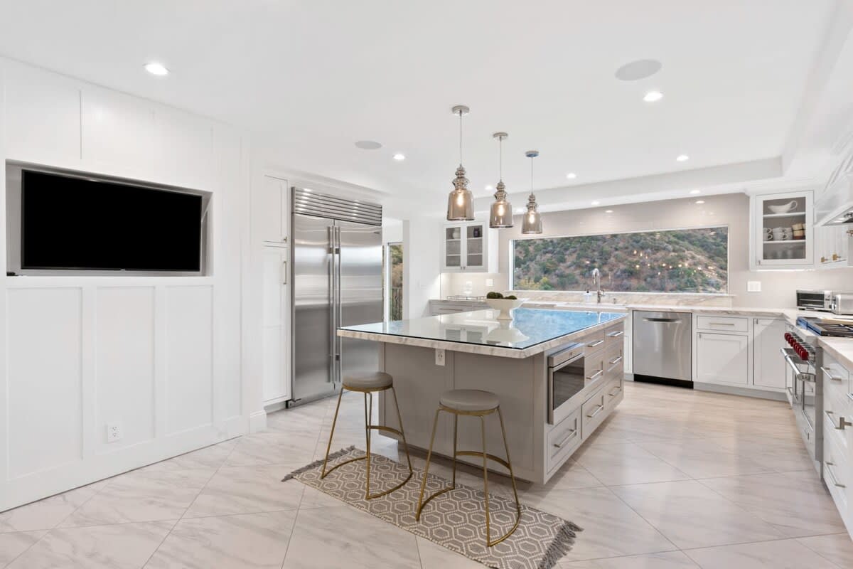 State of the Art appliances and sub zero refrigerator compliment this modern kitchen.