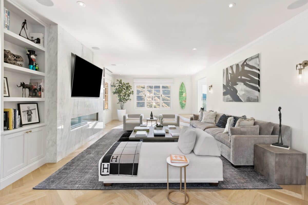 Large living entertaining space with High art pieces, state of the art technology and a fireplace. No expense was spared with furnishings for this Beverly Hills home.