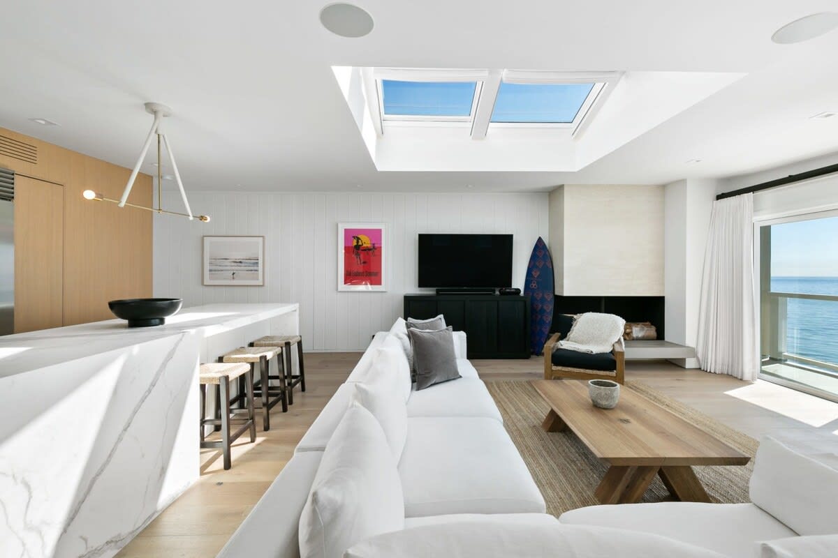 Skylight over the living room beaming in natural night. Option to close feature.