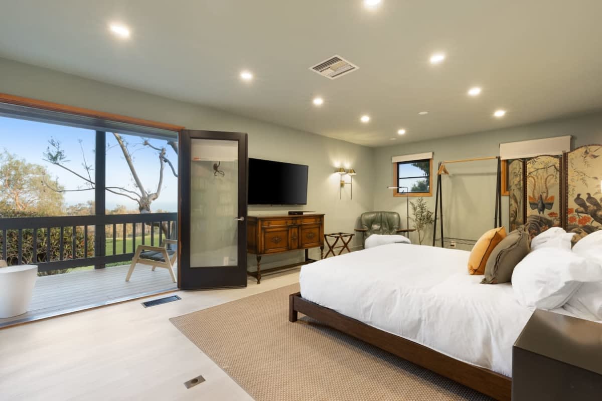 Relax in the Downstairs Guest bedroom with fresh air from the balcony