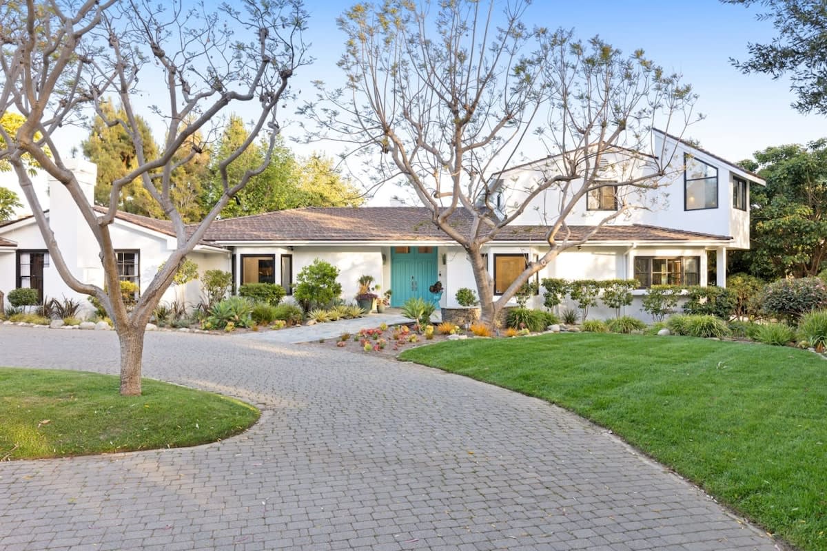 Let the beautiful garden and sprawling lawn welcome you home as you reach the front entrance!