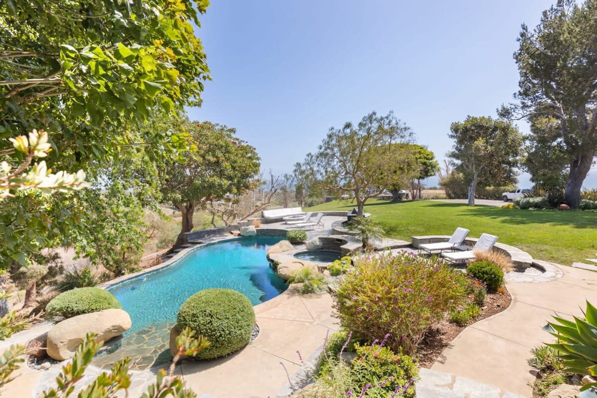 Wrapped with luscious lawns and green trees.