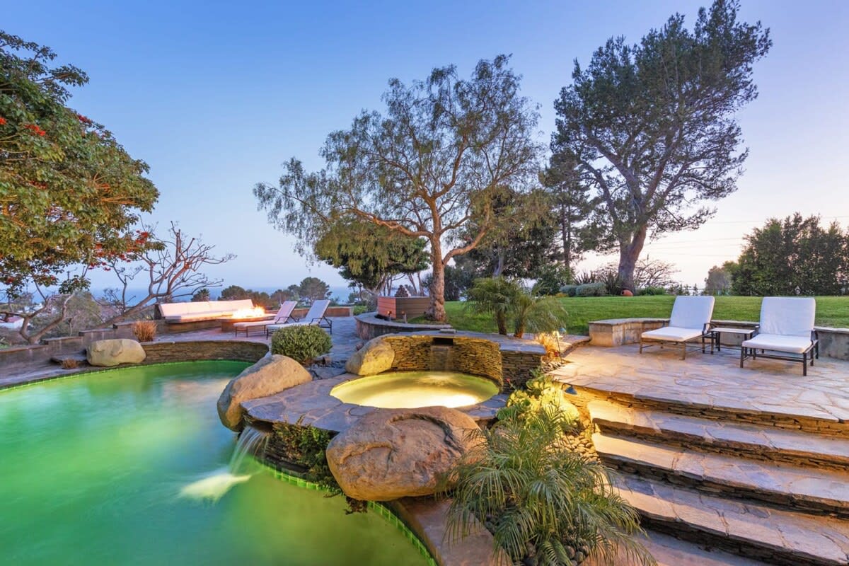 Pool, Jacuzzi, Fireplace accompanied by plush loungers.