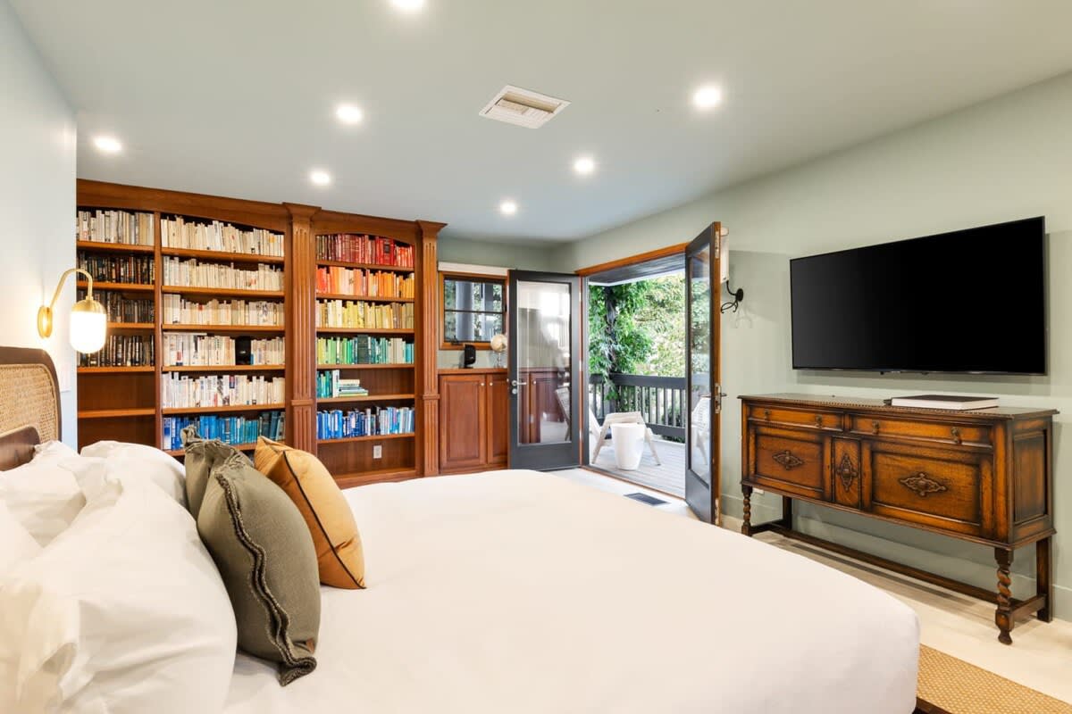 Wind down in Guest Bedroom 1, featuring beautiful wooden touches and unique furniture