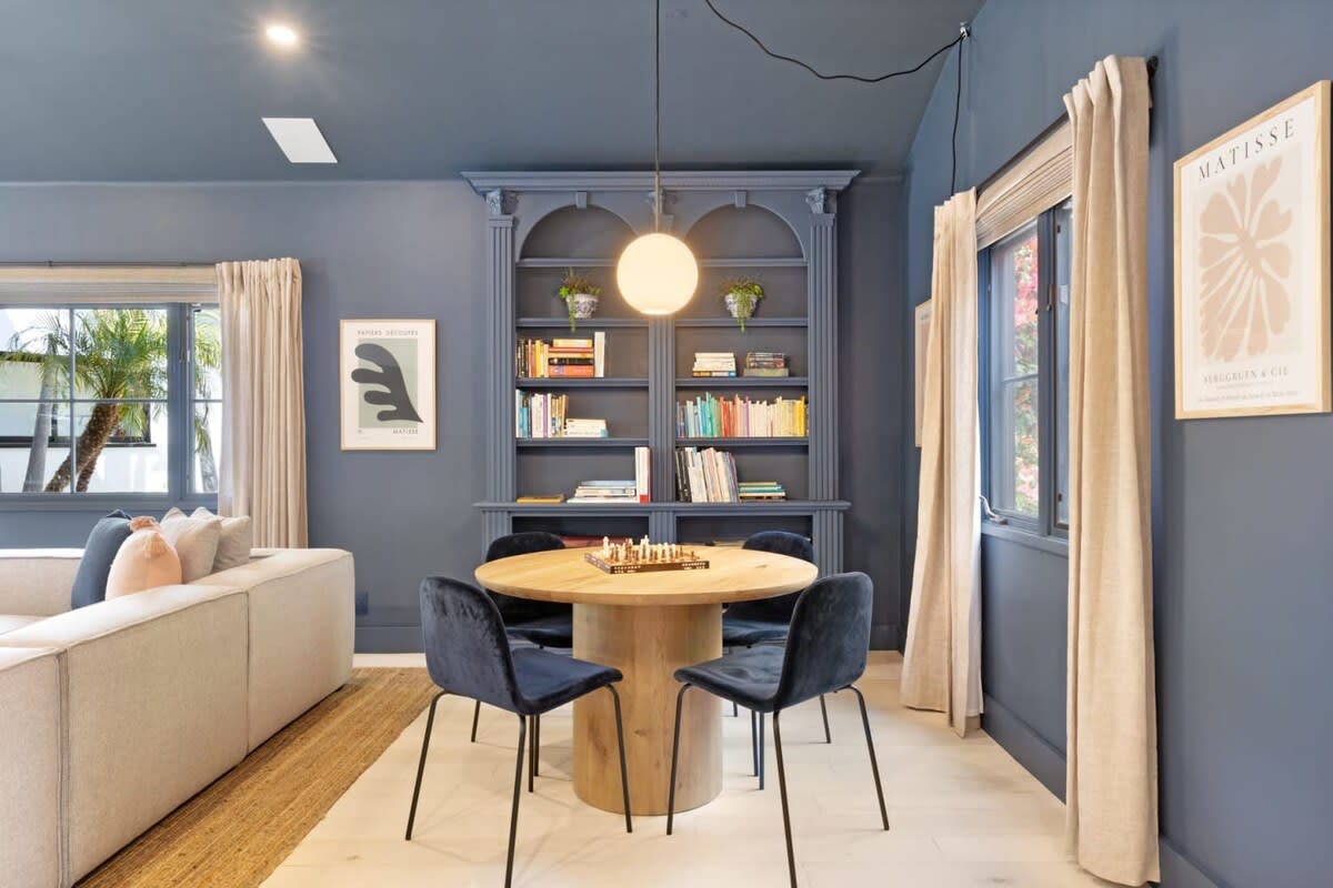 Cozy walls lined with books and art.