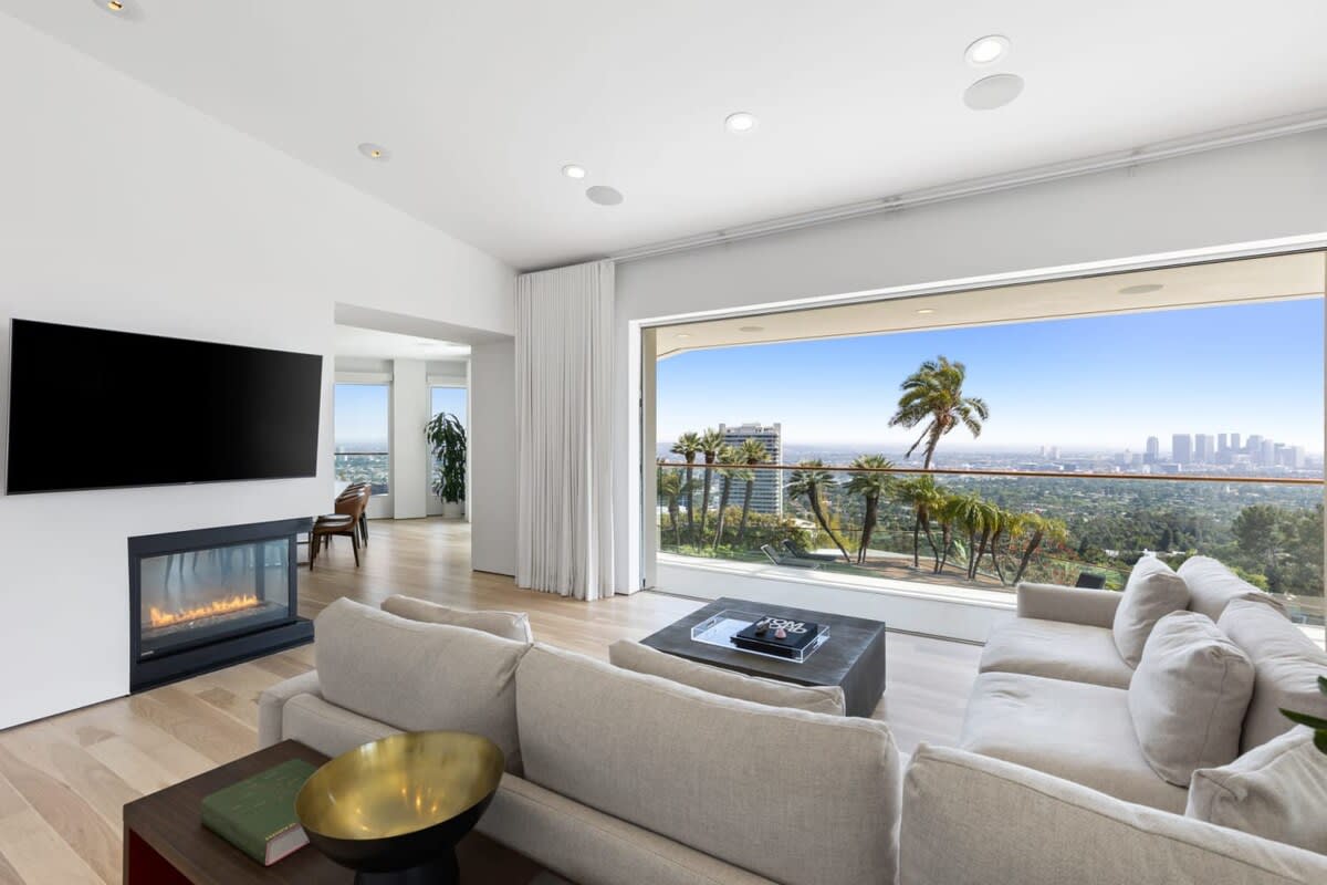Family room with electric fireplace, flat screen TV and luxurious views.