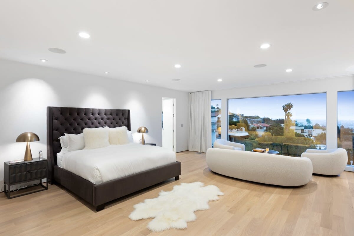 The Luxurious Master Bedroom has plenty of space and a private lounge overlooking the city.