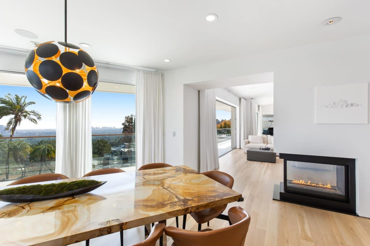 Dining space with a warming fireplace and everlasting views.