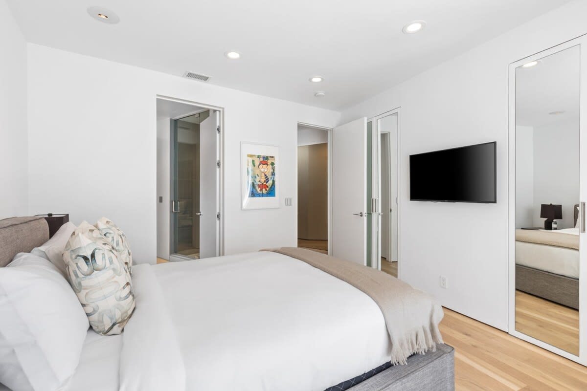 Guest Bedroom 2 features a smart tv and large mirror