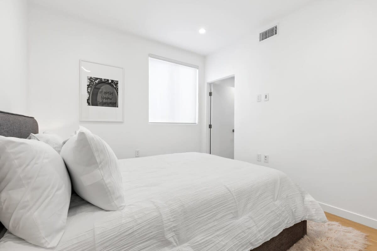 Upstairs guest bedroom with a clean and minimalistic design.