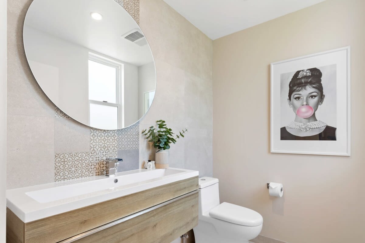 The main floor half bathroom has a clean and pleasant atmosphere.