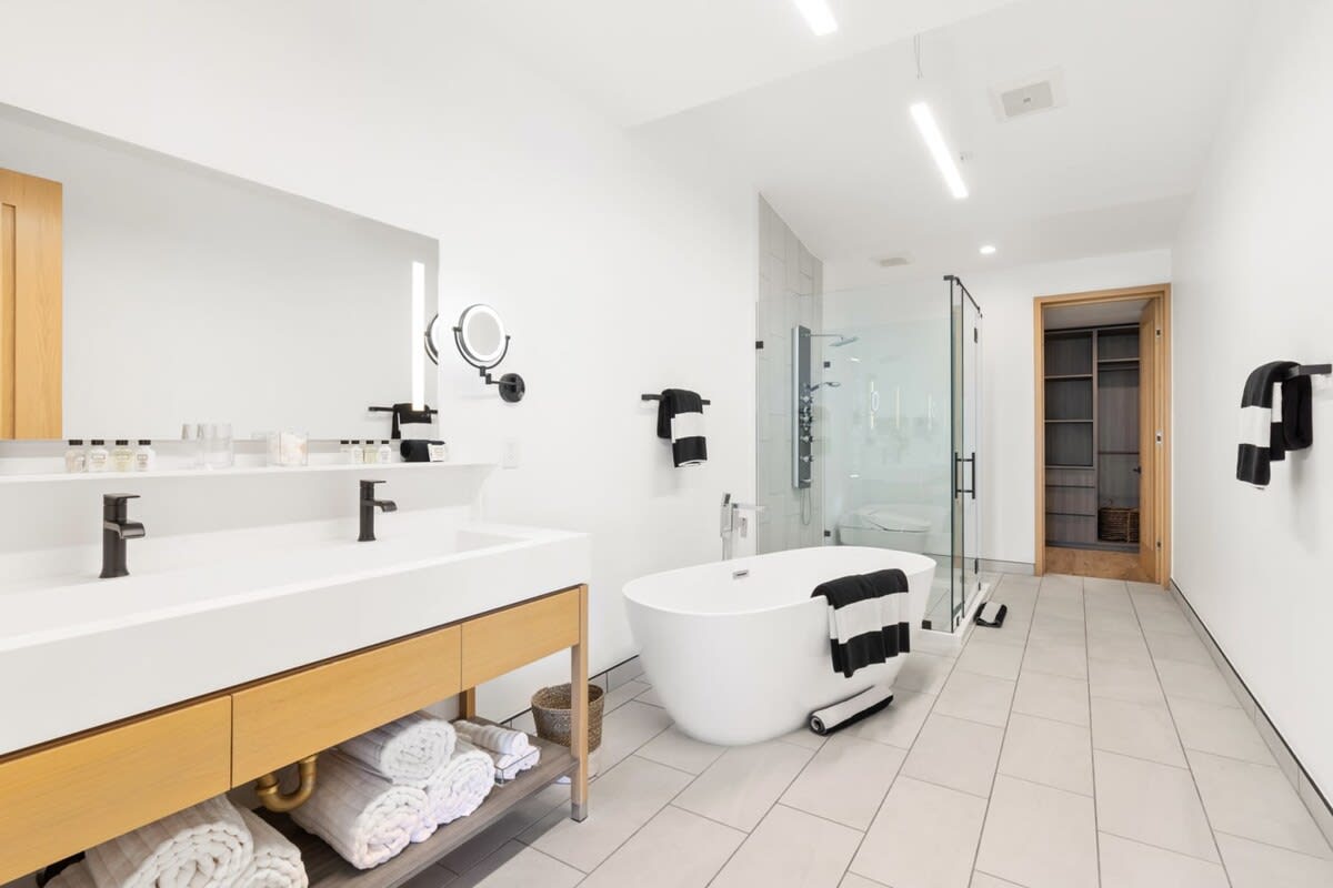 Conveniently designed, rain shower, separate soaking tub and LED lit vanity mirrors.