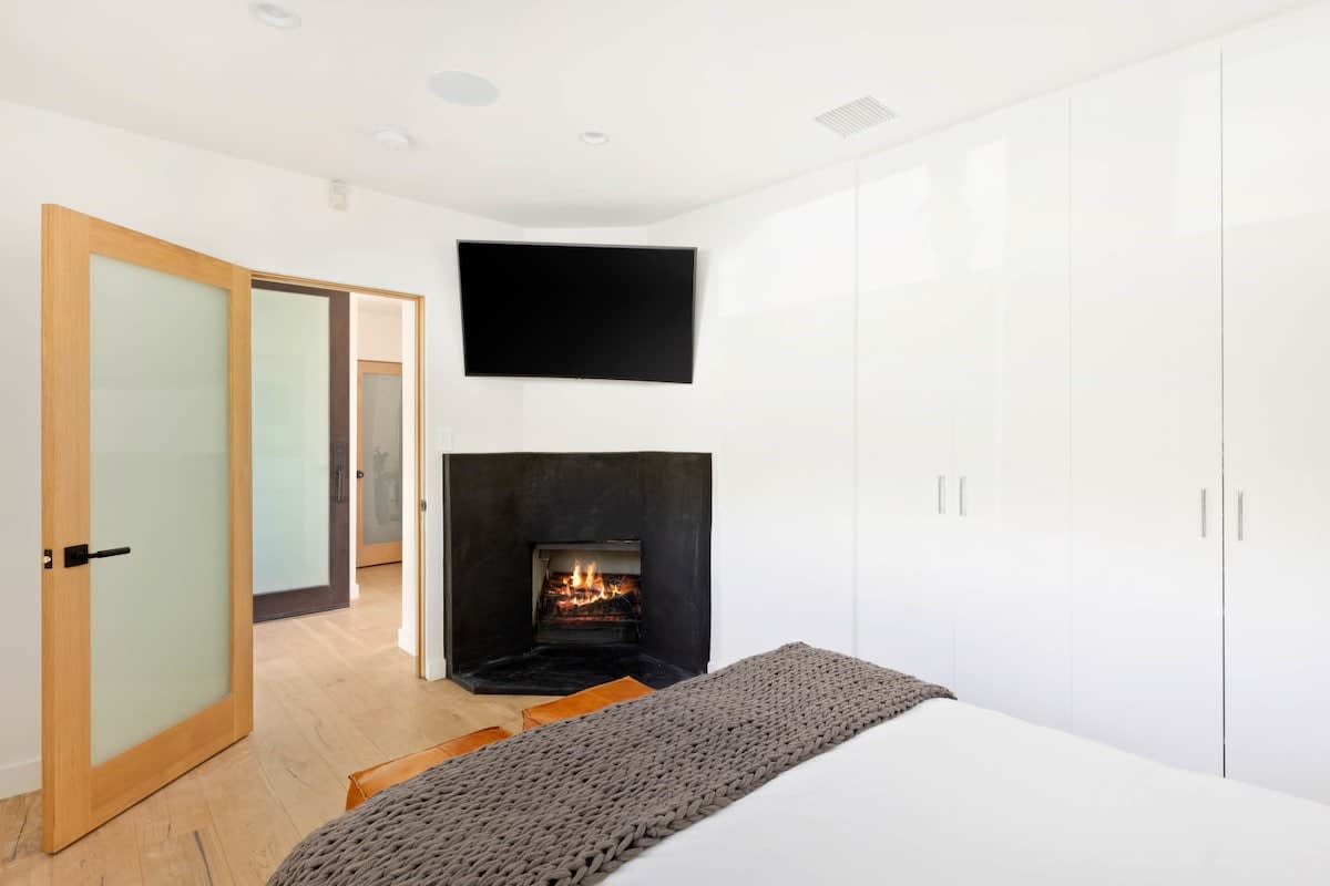 Cute bedroom with fireplace and curved LED TV