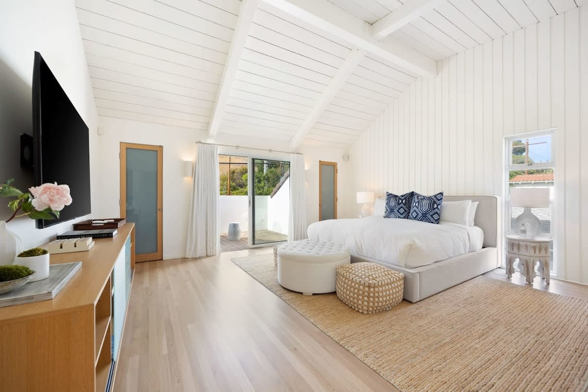 The high ceilings are lined with beautiful white wooden panels.