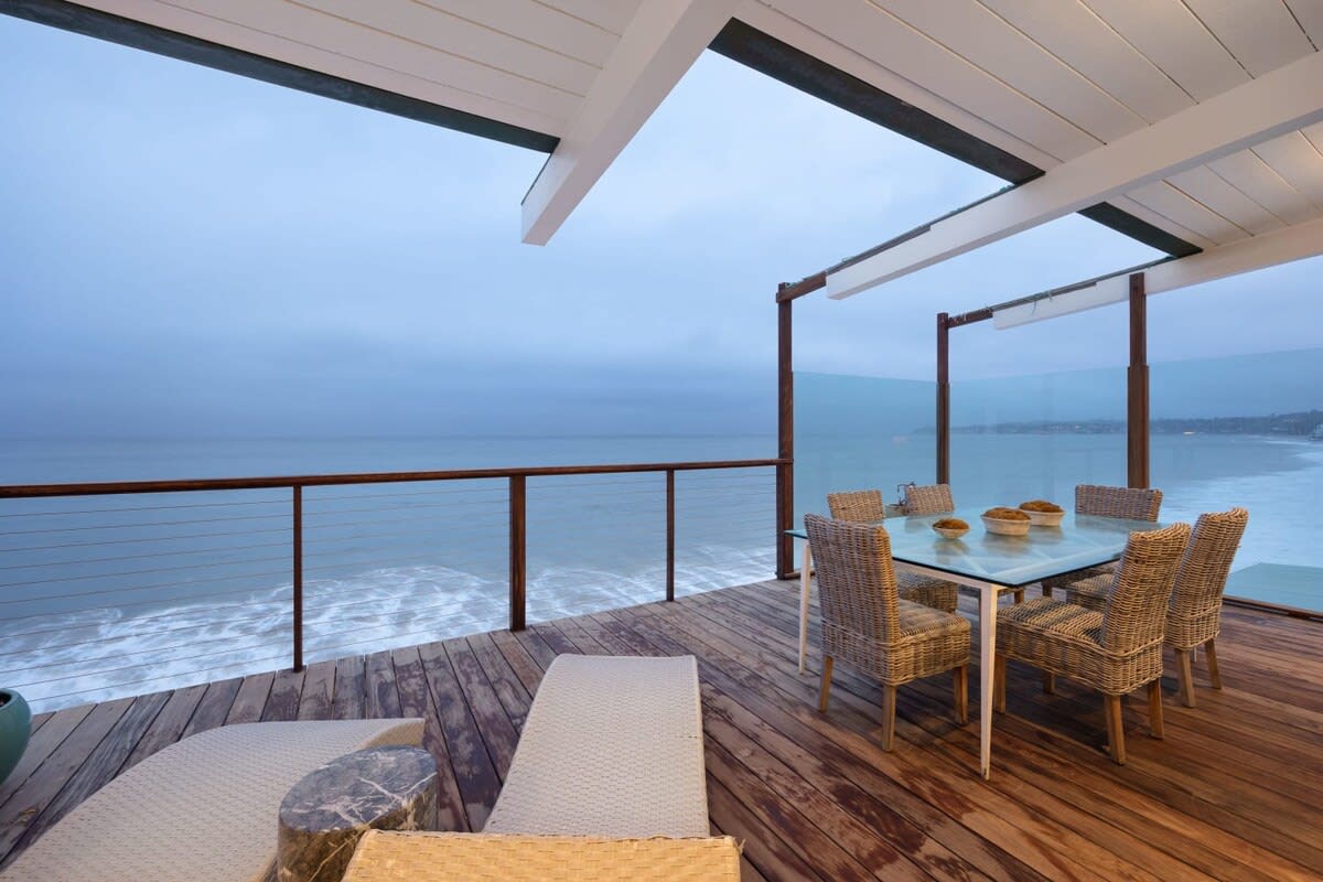 Dine outside with fresh air and a stunning view of the sunset over the ocean.