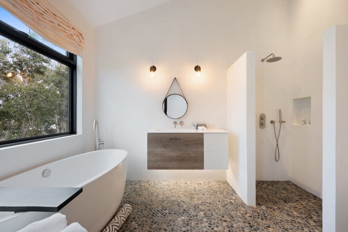 Relax and unwind in the luxurious tub with a glass of wine.