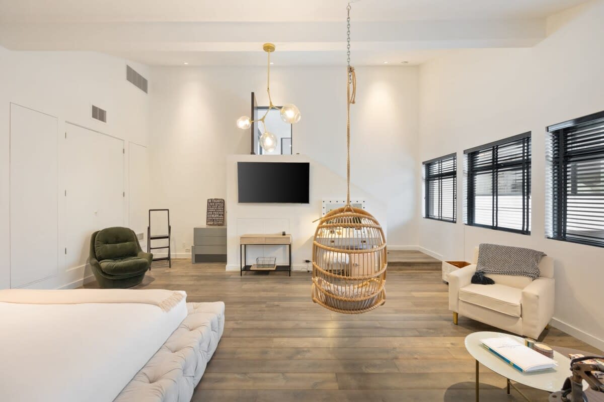 This guest bedroom boasts a generous lounge area with a flat-screen TV, for your enjoyment!