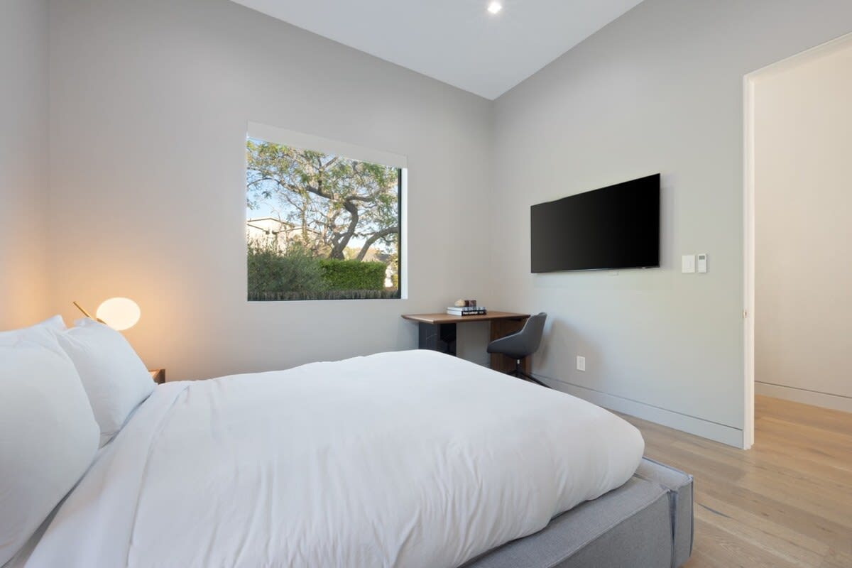 Relax on the soft bed infront of the flat screen TV