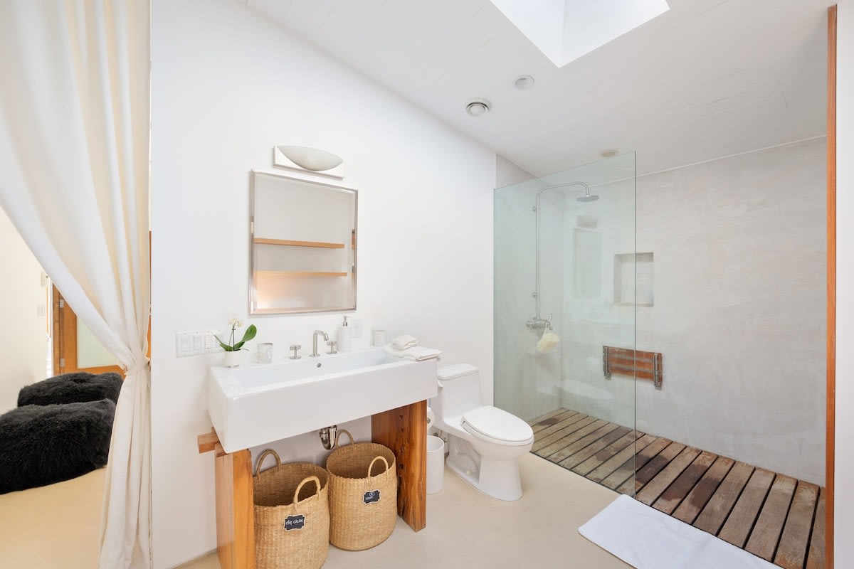Expansive bathroom featuring an invigorating shower and abundant natural light streaming in through the skylight.