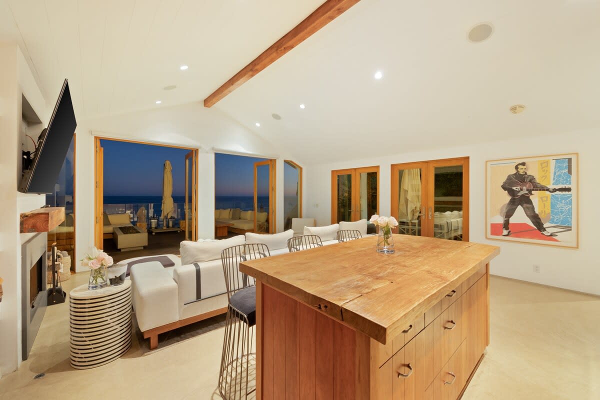 Additional seating at the wooden kitchen counter island.