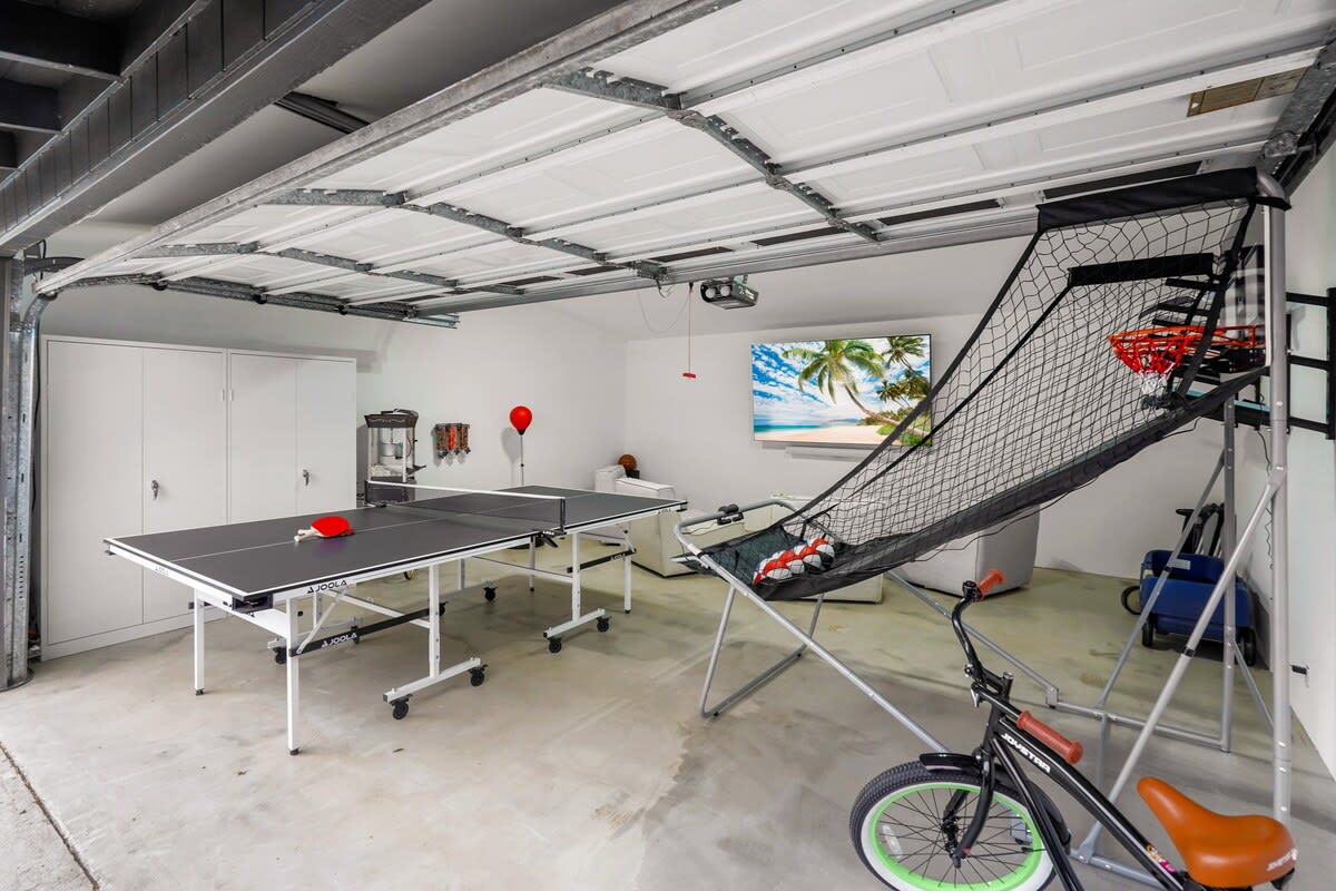 So much to do in 1 space! Workout equipment, basketball, ping pong, theater like seating, candy machine, popcorn machine, bikes, children's wagon, foam boards and boogie boards!!!