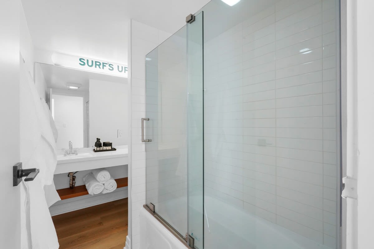 Shower + Tub with robes and hotel style toiletries. Shared bath for guest bedrooms.