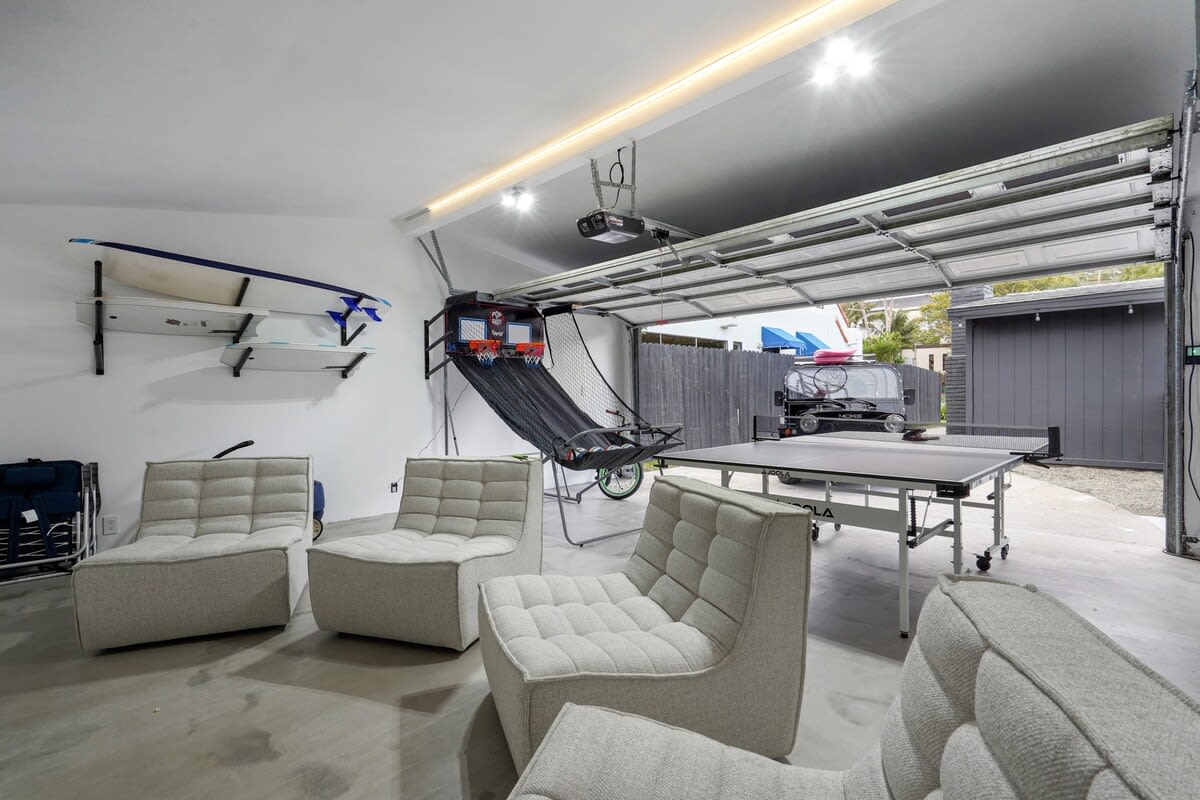 So much to do in 1 space! Workout equipment, basketball, ping pong, theater like seating, candy machine, popcorn machine, bikes, children's wagon, foam boards and boogie boards!!!