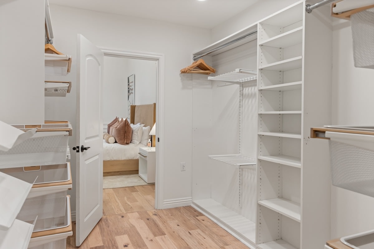 Step into a walk-in closet exuding chic elegance, providing a stylish haven for your wardrobe.