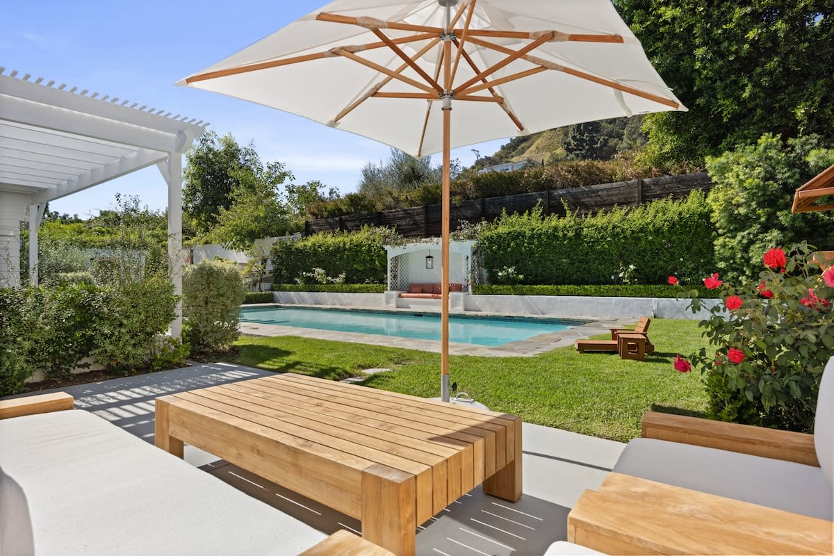 Unwind in this outdoor lounge, where the sun meets comfort, creating a perfect setting by the pool for relaxation.